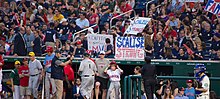 Baseball fans near the dugout hold signs saying "Capitol police MVP" and "Scalise Strong".
