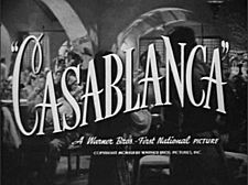 Black-and-white film screenshot with the title of the film in fancy font. Below it is the text "A Warner Bros. – First National Picture". In the background is a crowded nightclub filled with many people.