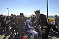 U.S. Navy Capt. Karl O. Thomas, right foreground, the commanding officer of the aircraft carrier USS Abraham Lincoln (CVN 72), speaks with an attendee during a Veterans Day ceremony Nov. 8, 2013