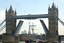 ☎∈ A tall ship passing under Tower Bridge decorated for the London Olympics in August 2012.