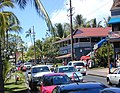Photograph of a street in Lāhainā, with cars, pedestrians, and historic buildings.