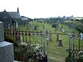 Kirkmaiden church built AD1638 with Core Hill Iron-Age fort in background.