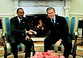 Traditional hand-shake photo seated in front of the fireplace. President G. W. Bush at right, the guest (Paul Kagame, President of Rwanda) to the left. One of the rare images where there is fire in the fireplace.
