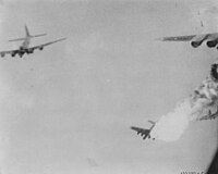 A B-17 bomber bursts into flames after being hit by flak over Ploiești