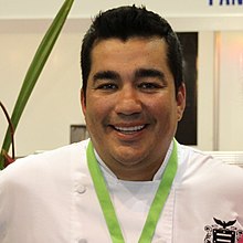 Garces wearing a white shirt, smiling