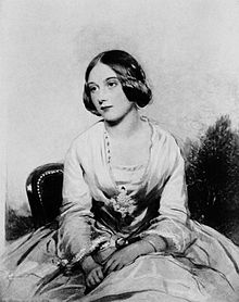 Black and white portrait of Edith Coleridge sitting in a chair