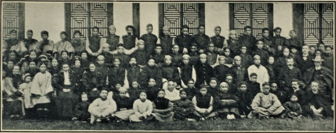 The visit of the deputation to Tongchuan in 1904, photographed outside the Meeting House. The three Members of the deputation, together with Isaac Mason and Edward B. Vardon, may be seen on the extreme right; Dr. Lucy Harris on the extreme left; and, nearer the centre, Esther L. Mason and Mira L. Cumber.