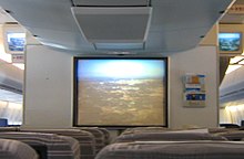 A television screen with the view of the city from the aircraft's nose camera