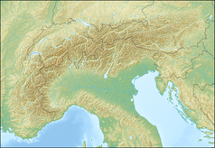 Mapa konturowa Alp, po lewej nieco u góry znajduje się owalna plamka nieco zaostrzona i wystająca na lewo w swoim dolnym rogu z opisem „Jezioro Genewskie”