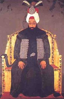 Portrait d'homme, barbu, en turban et en habits orientaux, assis sur un trône.