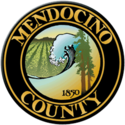 The county's official seal, in chief two redwood trees and the numbers '1850', a breaking wave on the Pacific Ocean and a vineyard set in relief, bordered by a dark brown circle with the words 'Mendocino County' appearing within the border in gold block letters