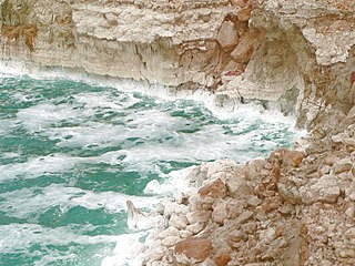 Прибой на Мёртвом море и солевые отложения на скалах
