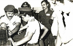 Abdullah (age 11) in uniform with soldiers