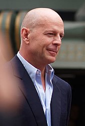 Bruce Willis watches as his star is presented to him on the Hollywood Walk of Fame