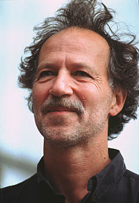 A profile image of Herzog with recent facial hair and wavy, unkept hair