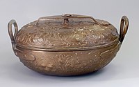 a copper pot inscribed with Hebrew letters and floral scrollwork