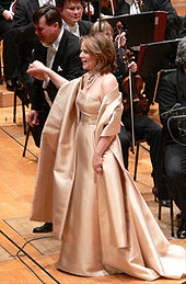 Fleming singing onstage with an orchestra