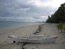 A white canoe on a beach
