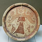 Fig. 3. Winged Gorgon with, volute nose, wide mouth, tusks/fangs, tongue, and beard, as Mistress of Animals flanked by geese; plate from Kameiros, Rhodes, British Museum A 748 (c. 630 BC)[53]