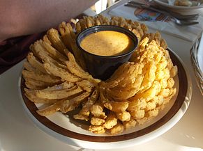 A blooming onion consists of one large onion which is cut to resemble a flower, battered and deep-fried.