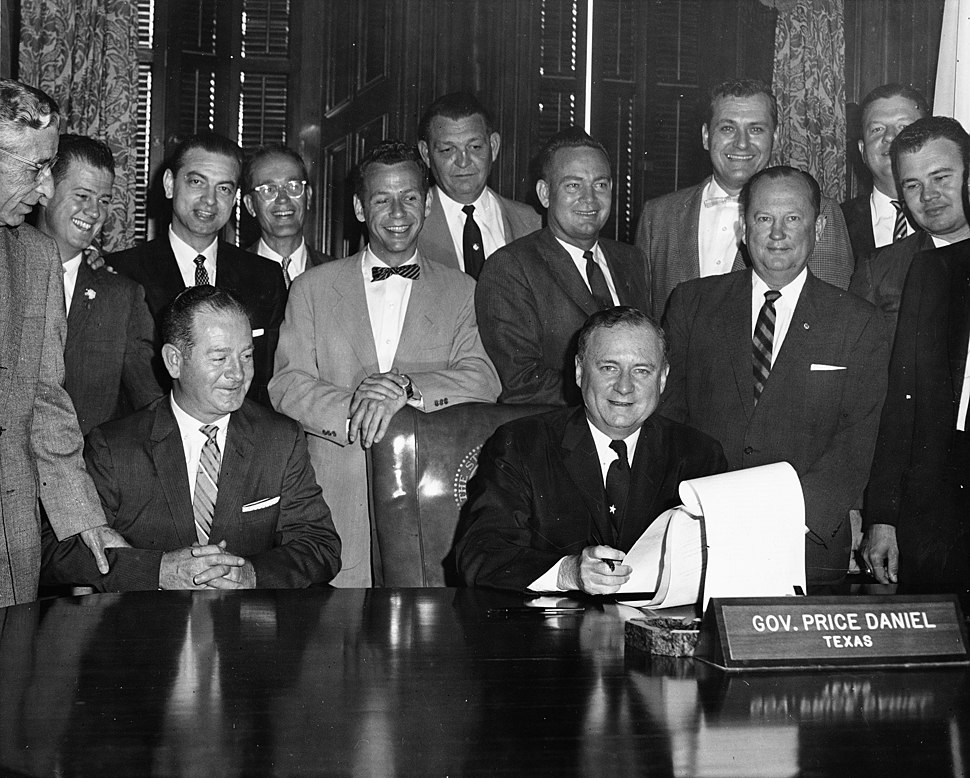 Texas Governor Price Daniel (seated) signing bill making Arlington State College a four-year college (10010616).jpg