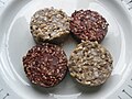 Two pieces of white pudding and two pieces of black pudding served on a white tray. This is a closeup photo of the food.