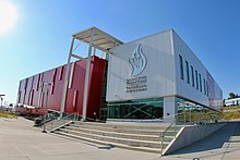 Building exterior clad in red and silver siding