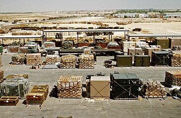 Pallets and containers of equipment sit in a logistics support area during Operation Desert Shield, 1991