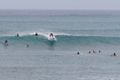 Surfers catching a wave.