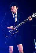 Angus Young, chitarist și compozitor australian, co-fondator al AC/DC