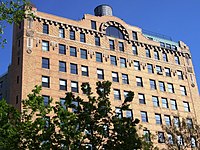 The "Cliff Dwelling", at the intersection with Riverside Drive, was designed by Herman Lee Meader and built in 1914.