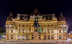 Frontal view of the Central University Library of Bucharest and Carol I statue, Bucharest, Romania.