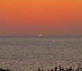 Зелёный луч при закате солнца 30 июня 2010 г. над морем на острове Гельголанд в Германии…