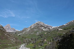 Castelmagno: at right the Santuario di San Magno (Saint Magnus's sanctuary), on background at center the Reina peak and at his feet the Grana valley
