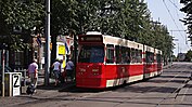 GTL 3097 op lijn 9. De wagen heeft een LVO (LevensVerlengend Onderhoud) ondergaan. Daarvan zichtbaar zijn een zachte neus, LED-verlichting en een nieuw kleurenschema. Halte Bierkade/Spui; augustus 2012.