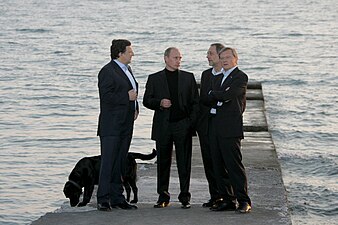 Konni looks down while José Manuel Barroso, Vladimir Putin, Javier Solana, and Wolfgang Schuessel have a discussion.