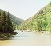 Bzyb river, flowing through interlocking spurs, with conifers on the left bank and deciduous trees on the right