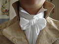 A Regency-style neckcloth tied in a bow on a Grafton collar