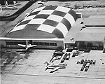 A hangar at Yuma AFB, with one of the B-45A target tugs inside