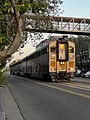 An Amtrak train running through Jack London Square in Oakland, California