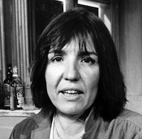 black and white headshot of Commire - a white woman with shoulder length dark hair