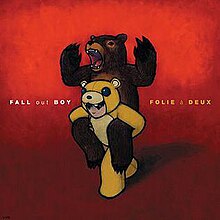 A drawing of a young boy, dressed in a bear costume, giving a piggyback ride to an actual bear, on a red background. The band's name and the album title are written to the left and right of the drawing, respectively.