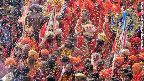 Indian devotees shower flower petals on Hindu holy men during a religious procession towards the Sangam area during the &#39;royal entry&#39; for the upcoming Kumbh Mela festival in Allahabad on January 2, 2019. - The festival attracts millions of Hindu pilgrims to the sacred confluence of the Yamuna and Ganges rivers over 49 days between January 15 and March 4. (Photo by SANJAY KANOJIA / AFP)        (Photo credit should read SANJAY KANOJIA/AFP/Getty Images)