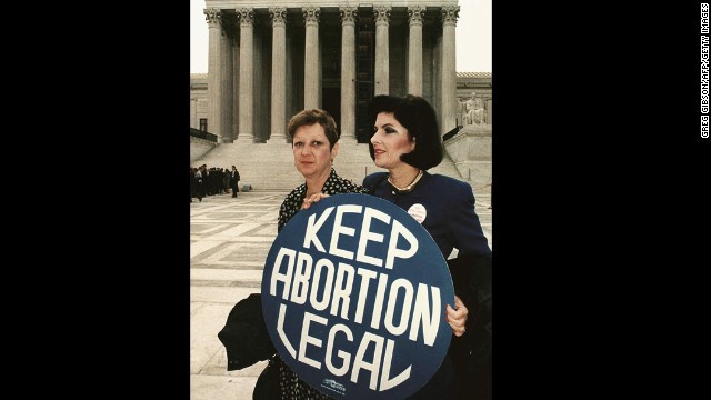 WASHINGTON, DC - APRIL 26: This file photo shows Norma McCorvey(L) formally known as &#39;Jane Roe&#39;,as she holds a pro-choice sign with former attorney Gloria Allred(R) in front of the US Supreme Court building 26 April 1989,in Washington,DC, just before attorneys began arguing the 1973 landmark abortion decision which legalized abortion in the US. (Photo credit should read GREG GIBSON/AFP/Getty Images)