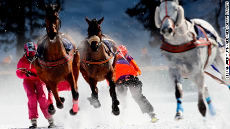 Competitors take part in the Skikjoering race at the White Turf horse racing event held on the frozen lake of the Swiss mountain resort of St. Moritz on February 17, 2019. - More images can be found on www.afpforum.com. Search slug: HORSE-RACING-SWITZERLAND (Photo by STEFAN WERMUTH / AFP)        (Photo credit should read STEFAN WERMUTH/AFP/Getty Images)