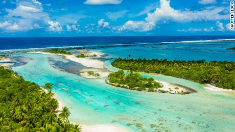 Rangiroa aerial drone video of atoll island motu and coral reef in French Polynesia, Tahiti. Amazing nature landscape with blue lagoon and Pacific Ocean. Tropical island paradise in Tuamotus Islands.