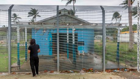 Asylum seeker Behrouz Boochani, stands outside the abandoned naval base on Manus island, where he and other asylum seekers were locked up for the first three years.