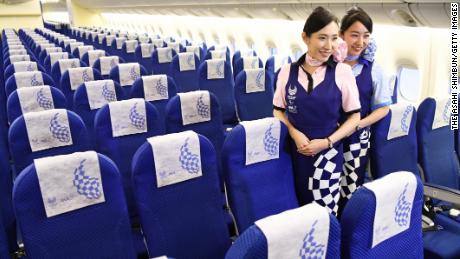 TOKYO, JAPAN - JANUARY 28:  (CHINA OUT, SOUTH KOREA OUT) Cabin crews pose in the &#39;Hello 2020 Jet&#39; of the All Nippon Airways during the press preview at a hangar of Haneda Airport on January 28, 2018 in Tokyo, Japan.  (Photo by The Asahi Shimbun via Getty Images)
