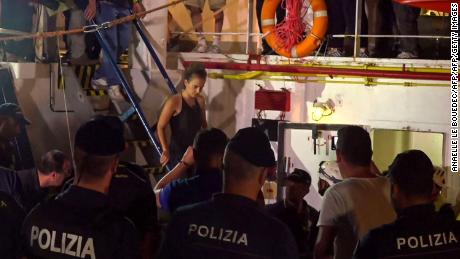 An image grab taken from a video released by Local Team on June 29, 2019, shows the Sea-Watch 3 charity ship&#39;s German captain Carola Rackete being arrested by Italian police, in the Italian port of Lampedusa, Sicily. - The Sea-Watch 3 charity ship carrying dozens of migrants rescued off Libya forced its way into the Italian port of Lampedusa on June 28 night after a lengthy standoff, the charity said. The boat&#39;s German captain Carola Rackete, 31, was arrested and the 40 migrants were still on board after the vessel docked. After manoeuvring the ship into port without permission, Rackete was arrested by police for refusing to obey a military vessel, a crime punishable by between three and 10 years in jail. She offered no resistance and was escorted off the vessel without  handcuffs. (Photo by Anaelle LE BOUEDEC / various sources / AFP) / Italy OUT        (Photo credit should read ANAELLE LE BOUEDEC/AFP/Getty Images)
