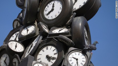 A pigeon stands on an installation of clocks by French artist Arman on March 24, 2012 in Paris. Europe moves to summer time at 0100 GMT on March 25 when clocks go forward an hour. AFP PHOTO/JOEL SAGET (Photo credit should read JOEL SAGET/AFP/Getty Images) 